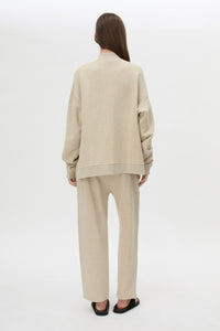 Back view CAMILLA AND MARC Lloyd Sweater in Cream with a ribbed turtleneck and an embroidered chest monogram.