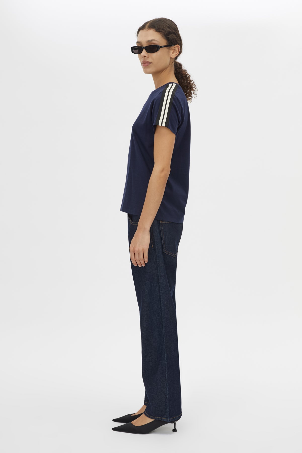 Side view CAMILLA AND MARC Locus Tee in Navy with fitted baby‑tee silhouette and contrast stripe tape.  
