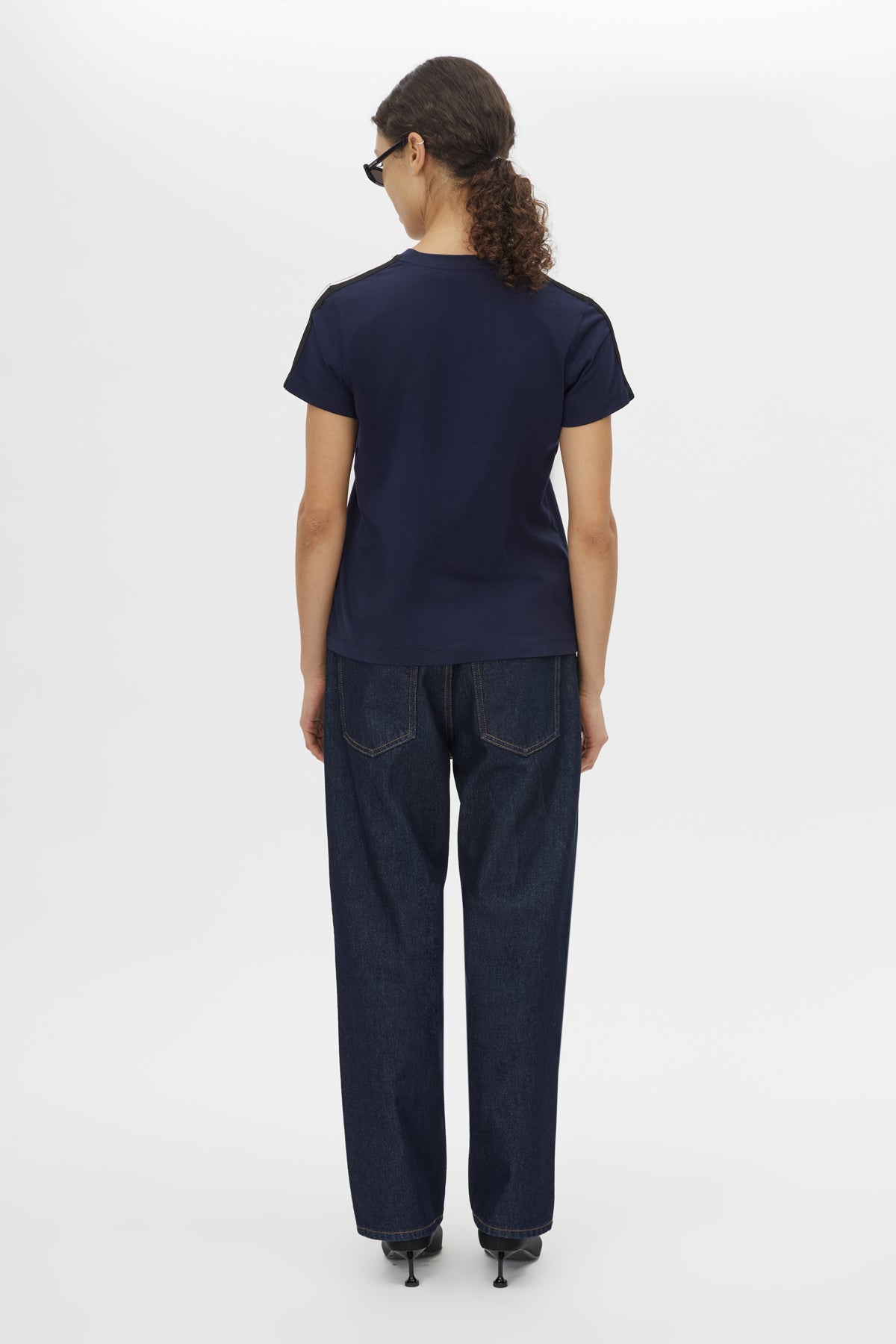 Back view CAMILLA AND MARC Locus Tee in Navy with fitted baby‑tee silhouette and contrast stripe tape.  