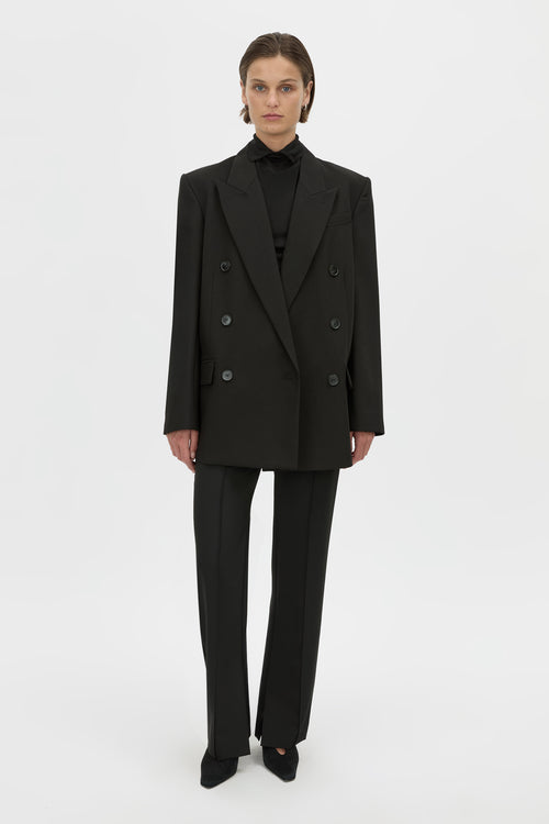 Front-styled view CAMILLA AND MARC Mackinley double-breasted black blazer with shoulder pads.