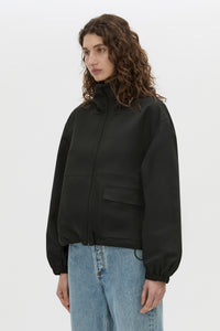 Cropped view CAMILLA AND MARC Mahdavi funnel neck jacket in black.