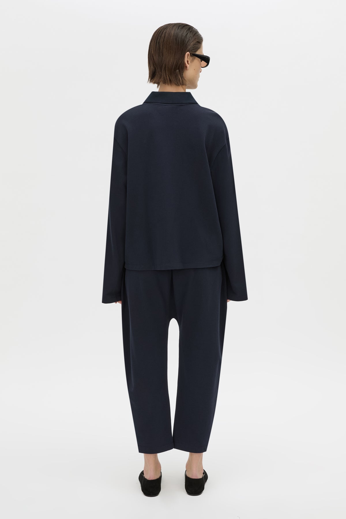 Back view CAMILLA AND MARC Moreno Pique Track Pant in navy with elastic‑encased waistband and embroidered eyelets and drawcord.