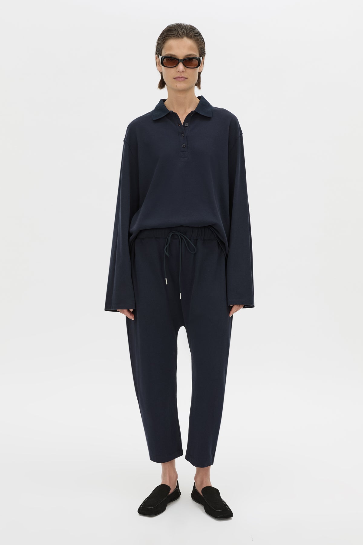 Front view CAMILLA AND MARC Moreno Pique Track Pant in navy with elastic‑encased waistband and embroidered eyelets and drawcord.