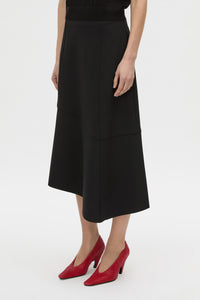 Cropped view CAMILLA AND MARC high-waisted Namira Midi Skirt in black with asymmetric hemline.