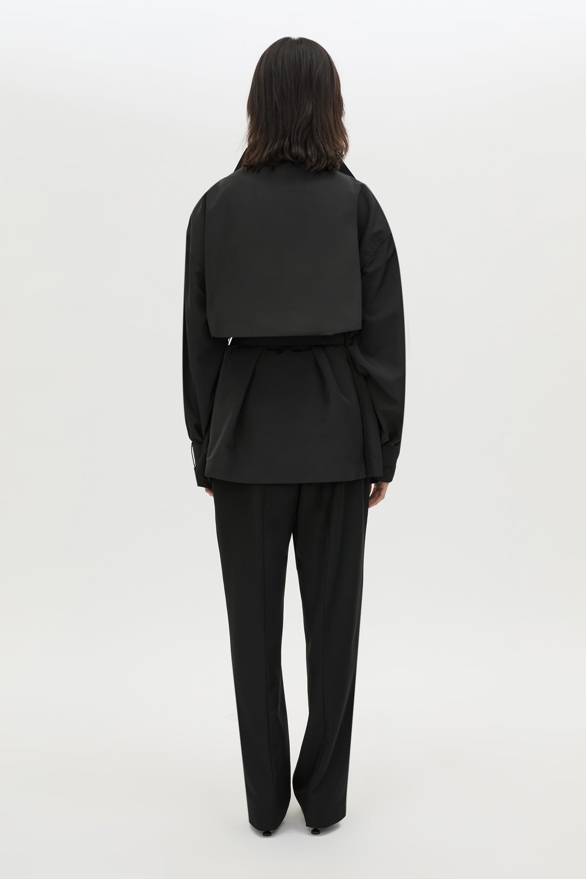 Back view CAMILLA AND MARC Nasir Cropped Jacket in Black with high‑neck, double‑breasted wrap design.