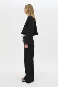 Side view CAMILLA AND MARC Niami Crochet Cropped Top in black with cut‑away crochet detailing at hem.