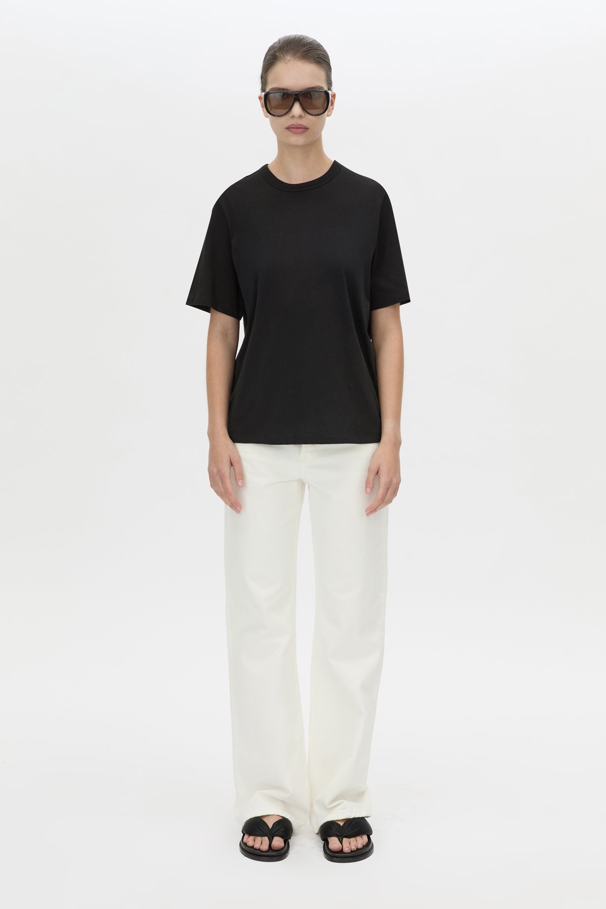 Front view CAMILLA AND MARC relaxed Olympia Print Tee in black with white plastisol artwork at centre back.