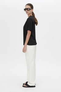 Side view CAMILLA AND MARC relaxed Olympia Print Tee in black with white plastisol artwork at centre back.
