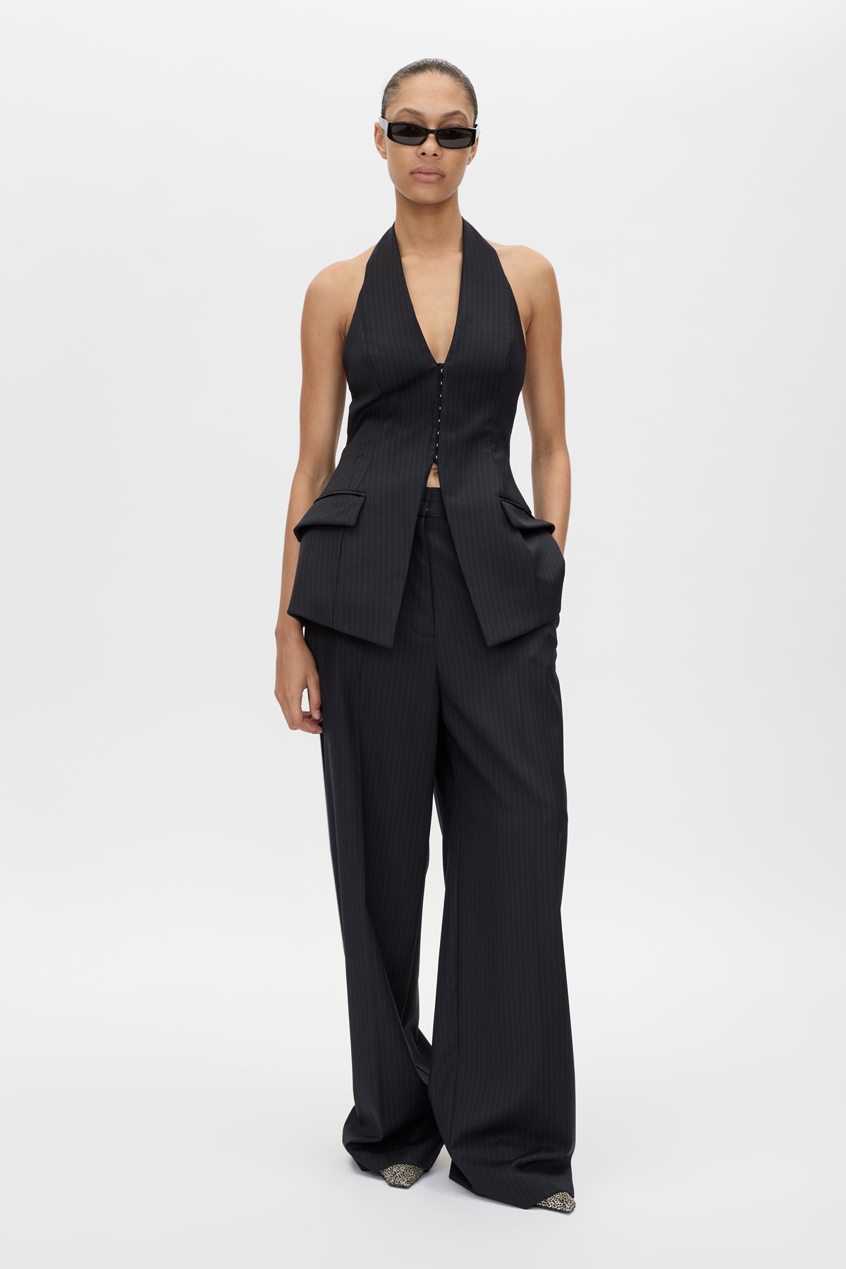 Front styled view CAMILLA AND MARC Orban Tailored Halter Top in Navy Pinstripe with deep V‑neck, fitted waist and open back.