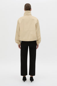 Back view CAMILLA AND MARC Oren Funnel Neck Jacket in ochre stripe with CAMILLA AND MARC monogram embroidery.