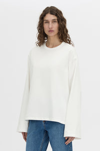 Cropped view CAMILLA AND MARC Peretti long sleeve tee in white with wide shaped sleeves.