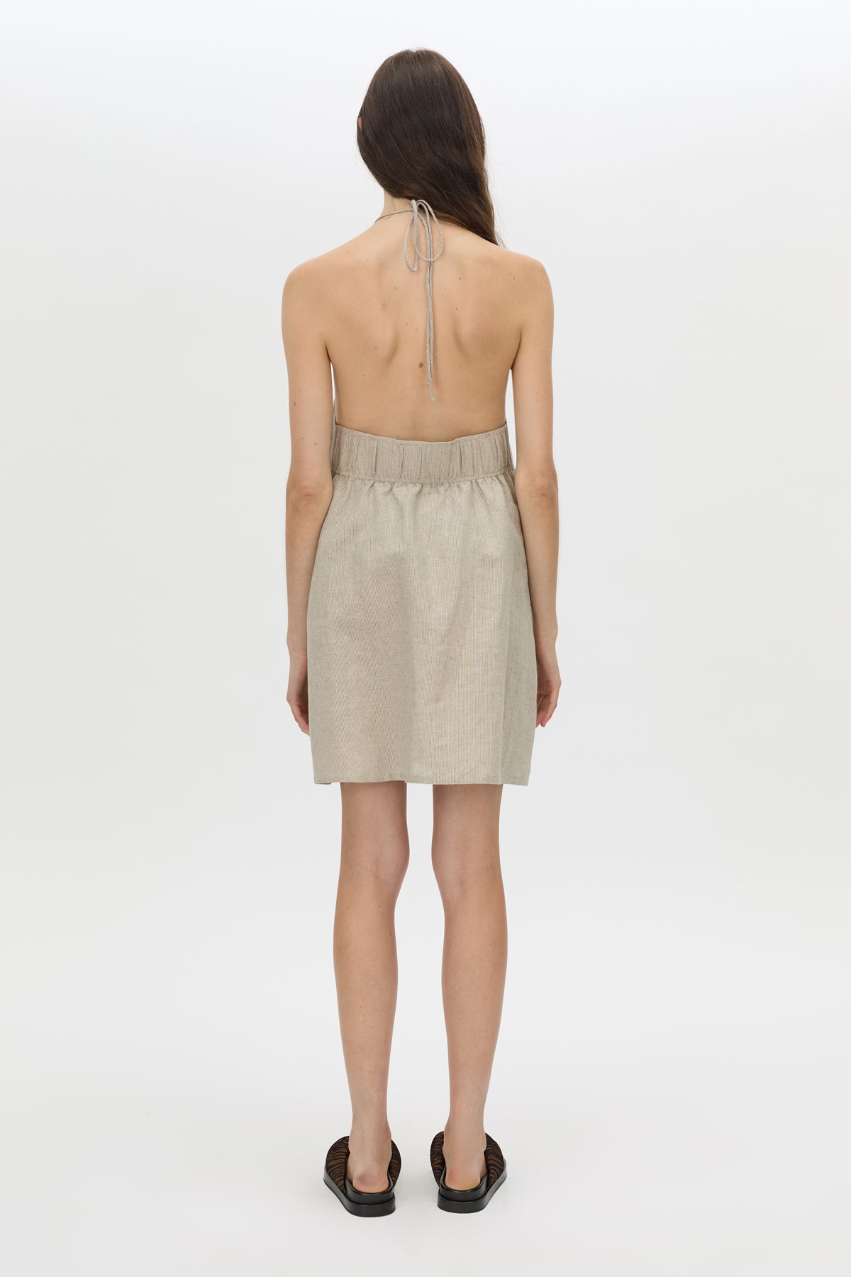 Back view CAMILLA AND MARC Phostre Halter Mini Dress in sand with a halter neckline.