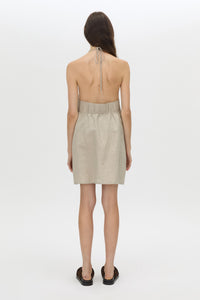 Back view CAMILLA AND MARC Phostre Halter Mini Dress in sand with a halter neckline.