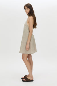 Side view CAMILLA AND MARC Phostre Halter Mini Dress in sand with a halter neckline.