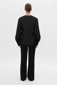 Back view CAMILLA AND MARC Rene Long Sleeve Top in black with adjustable neckline and blouson sleeves.