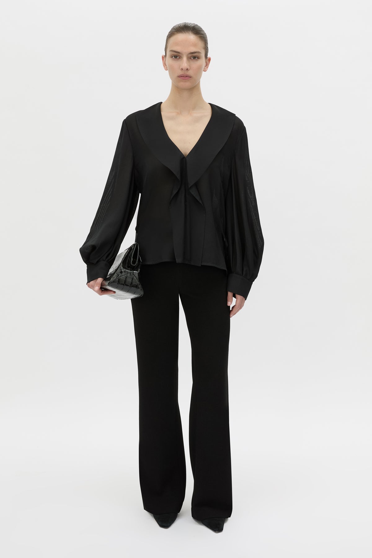 Front-styled view CAMILLA AND MARC Rene Long Sleeve Top in black with adjustable neckline and blouson sleeves.