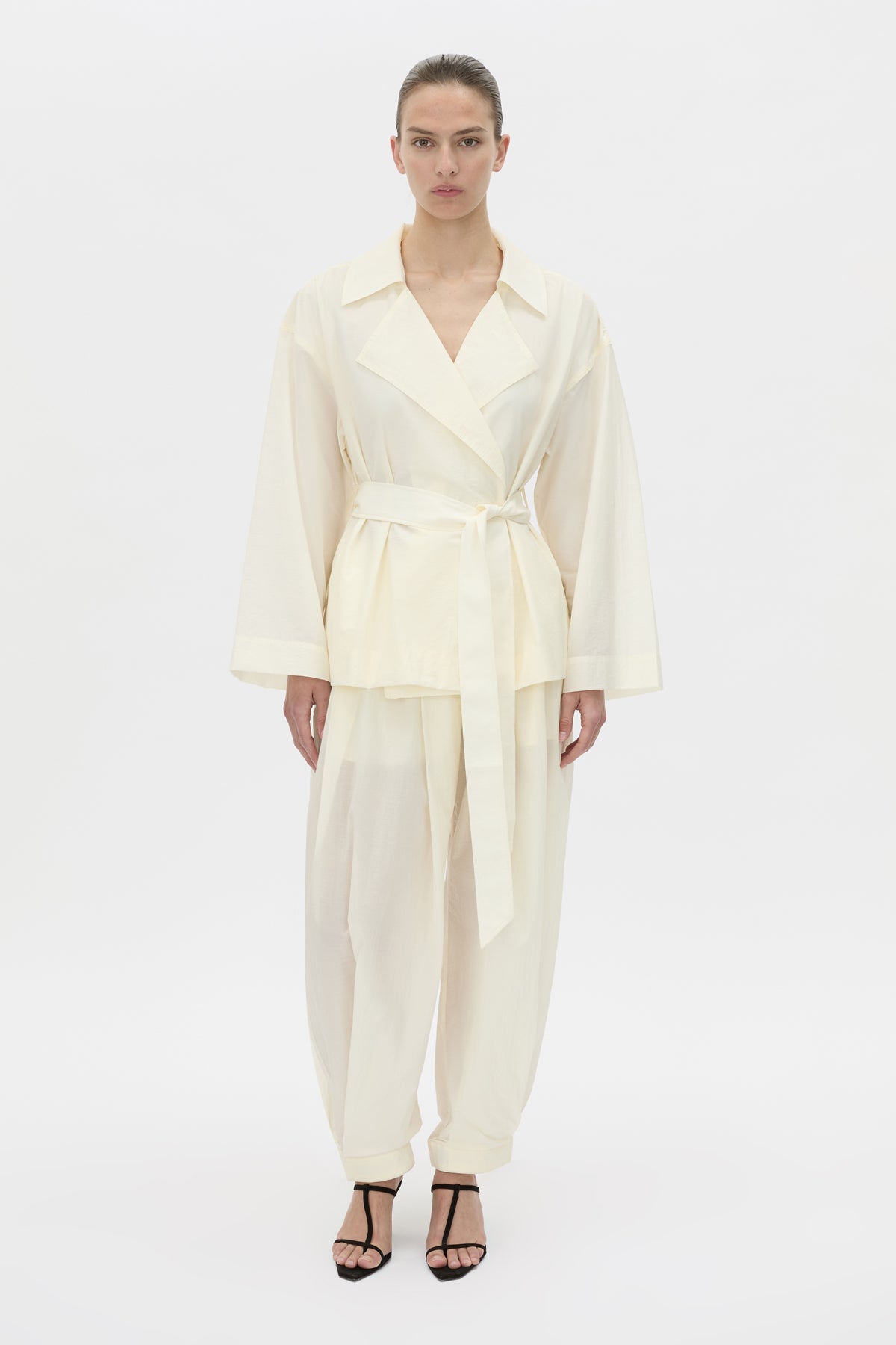 Front-styled view CAMILLA AND MARC Rhia Sheer Cropped Trench in ivory white with a relaxed fit.