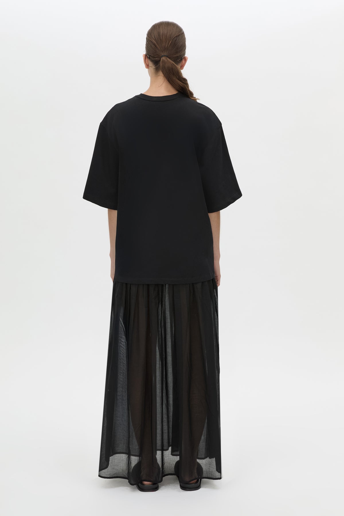 Back view CAMILLA AND MARC Romy Contrast Maxi Dress in black with upper cotton tee‑shirt and sheer voile extension.