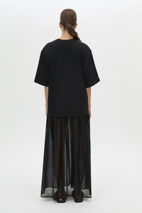 Back view CAMILLA AND MARC Romy Contrast Maxi Dress in black with upper cotton tee‑shirt and sheer voile extension.