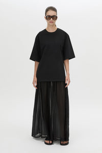 Front-styled view CAMILLA AND MARC Romy Contrast Maxi Dress in black with upper cotton tee‑shirt and sheer voile extension.