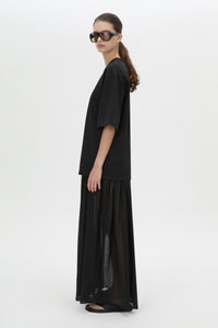 Side view CAMILLA AND MARC Romy Contrast Maxi Dress in black with upper cotton tee‑shirt and sheer voile extension.