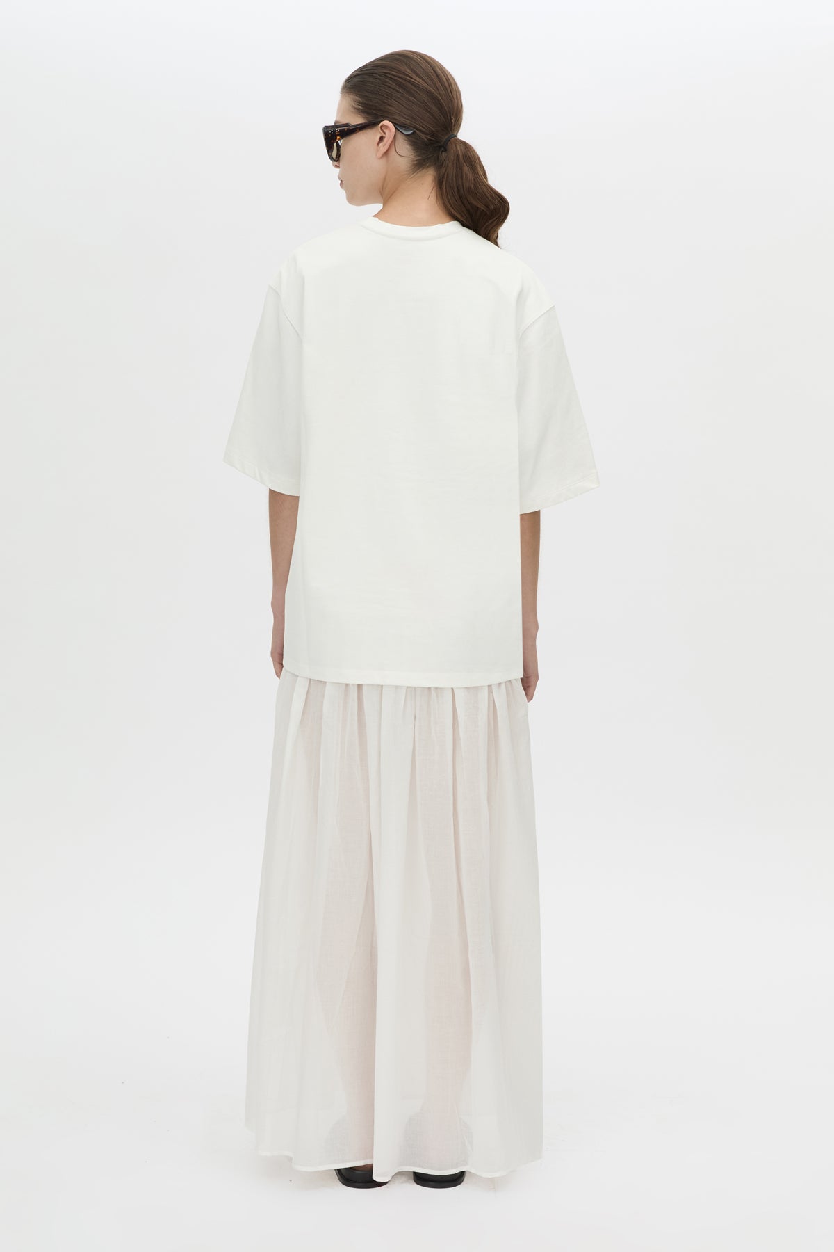 Back view CAMILLA AND MARC Romy Contrast Maxi Dress in soft white with upper cotton tee‑shirt and sheer voile extension.