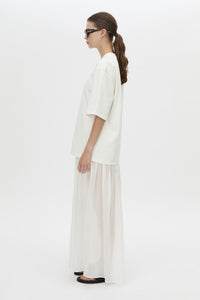 Side view CAMILLA AND MARC Romy Contrast Maxi Dress in soft white with upper cotton tee‑shirt and sheer voile extension.