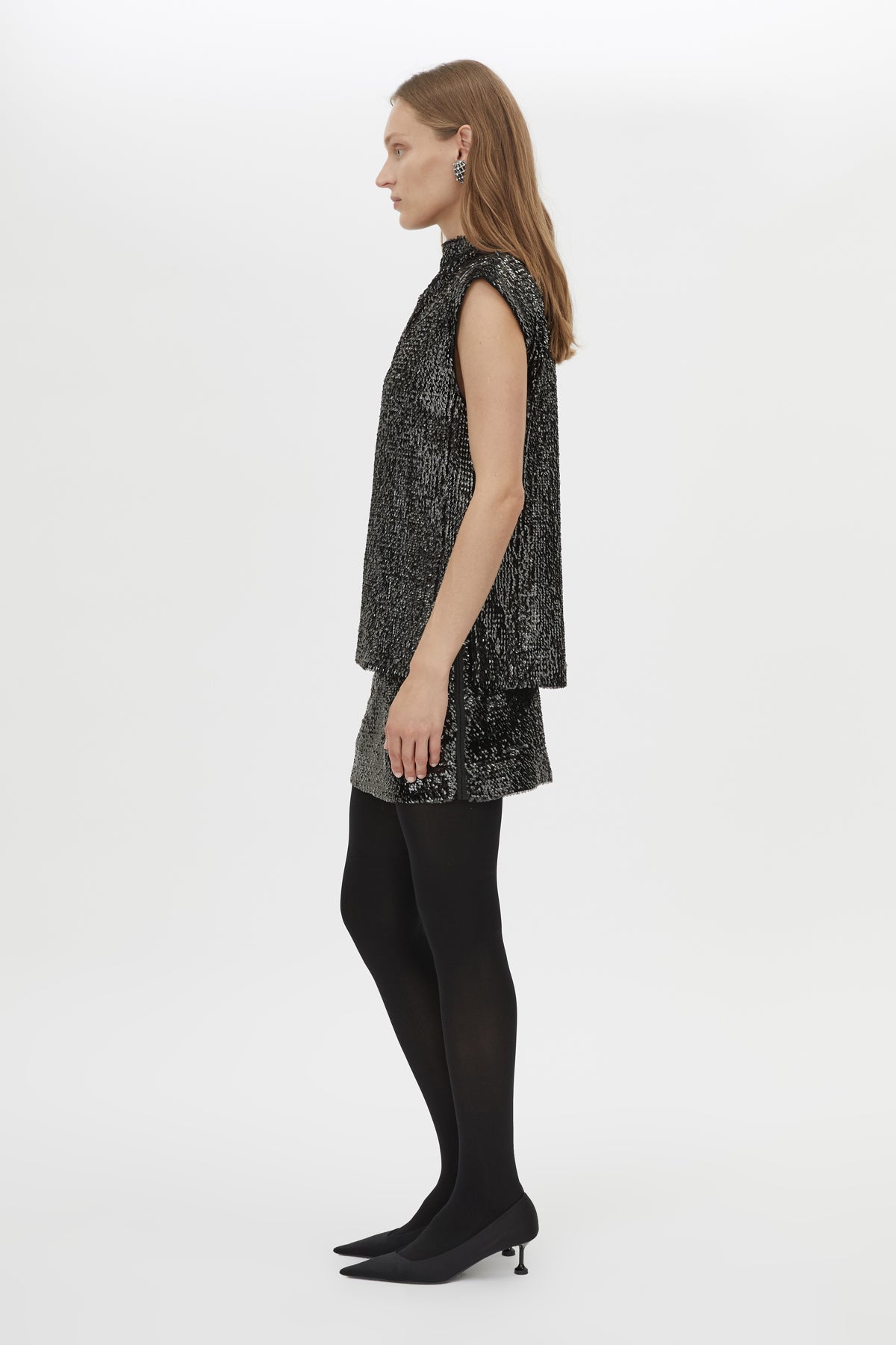 Side view CAMILLA AND MARC Sabel Skirt in Black with sequin finish and micro‑mini silhouette.