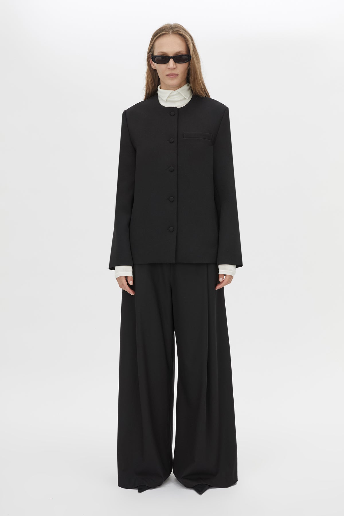 Front Styled View CAMILLA AND MARC San fitted collarless blazer in black with Front button closure.