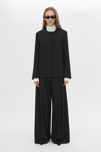 Front Styled View CAMILLA AND MARC San fitted collarless blazer in black with Front button closure.