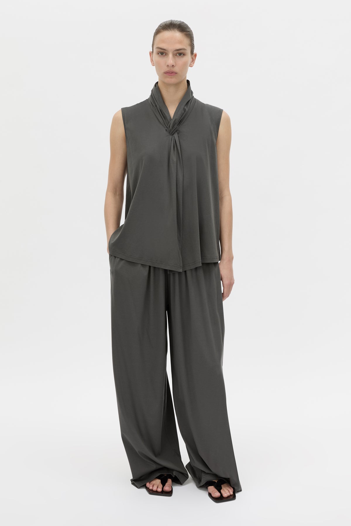 Styled view CAMILLA AND MARC Senae Draped Knot Sleeveless Top in charcoal grey.