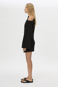 Side view CAMILLA AND MARC Serenitas Mini Dress in Black with off the shoulder long-sleeves.
