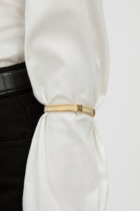 Close View - CAMILLA AND MARC Sleeve Monogram garter pair in gold. Worn on the arm to perfectly bunch up any sleeve.