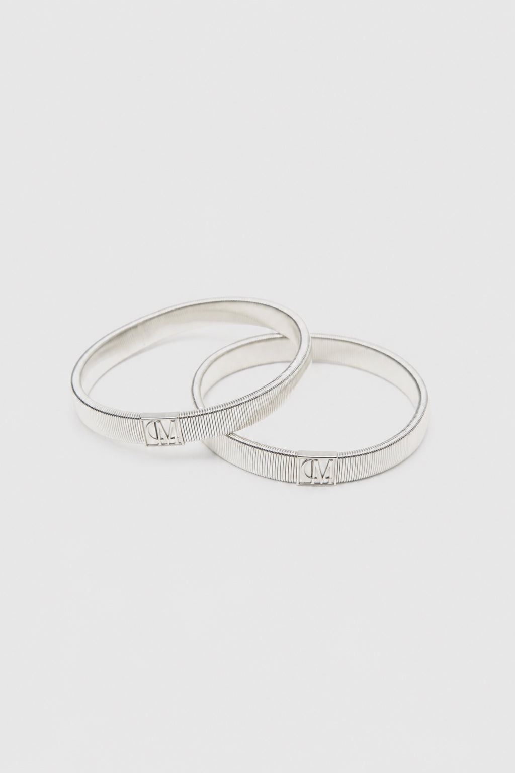 Ghost View - CAMILLA AND MARC Sleeve Monogram garter pair in silver. 