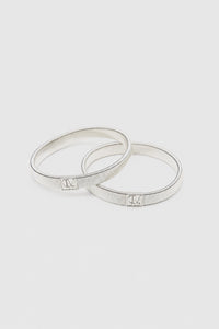 Ghost View - CAMILLA AND MARC Sleeve Monogram garter pair in silver. 