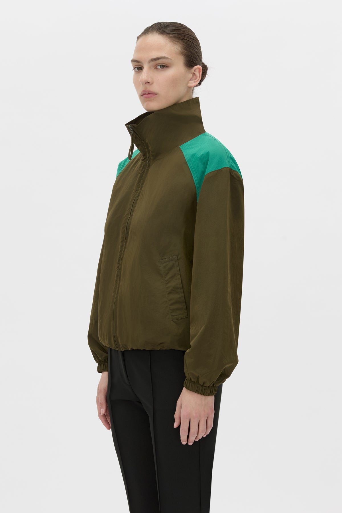 Cropped view CAMILLA AND MARC Storm Colour Block Anorak in khaki emerald with contrast shoulder panels and a funnel neckline.