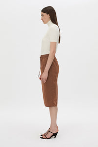 Side view CAMILLA AND MARC Storm Midi Skirt in mocha with an elasticated waistband, slanted side pockets and a back vent.