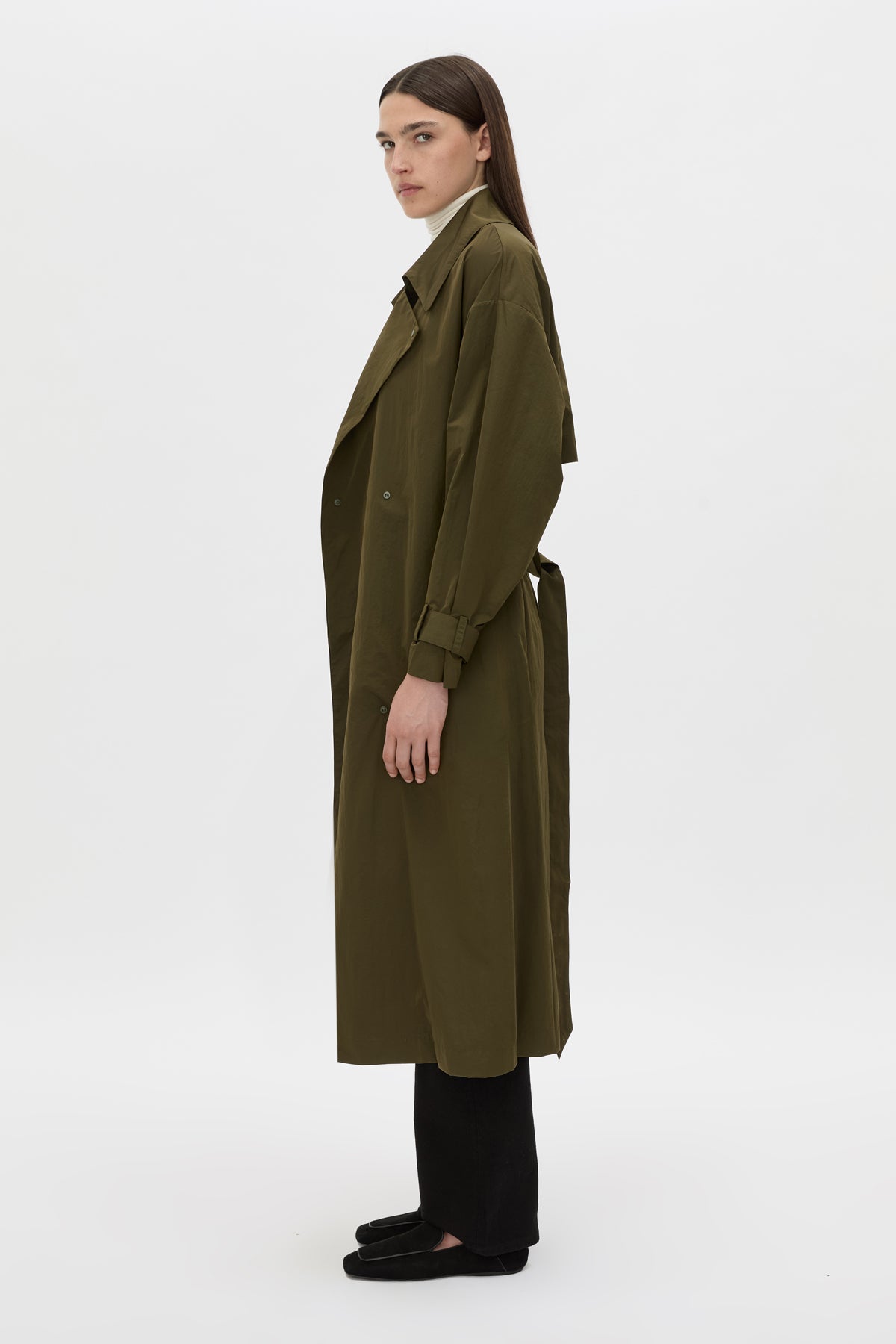 Side view CAMILLA AND MARC Storm Trench Coat in khaki with concealed snap fastenings, in seam pockets and a self tie belt with sleeve straps.