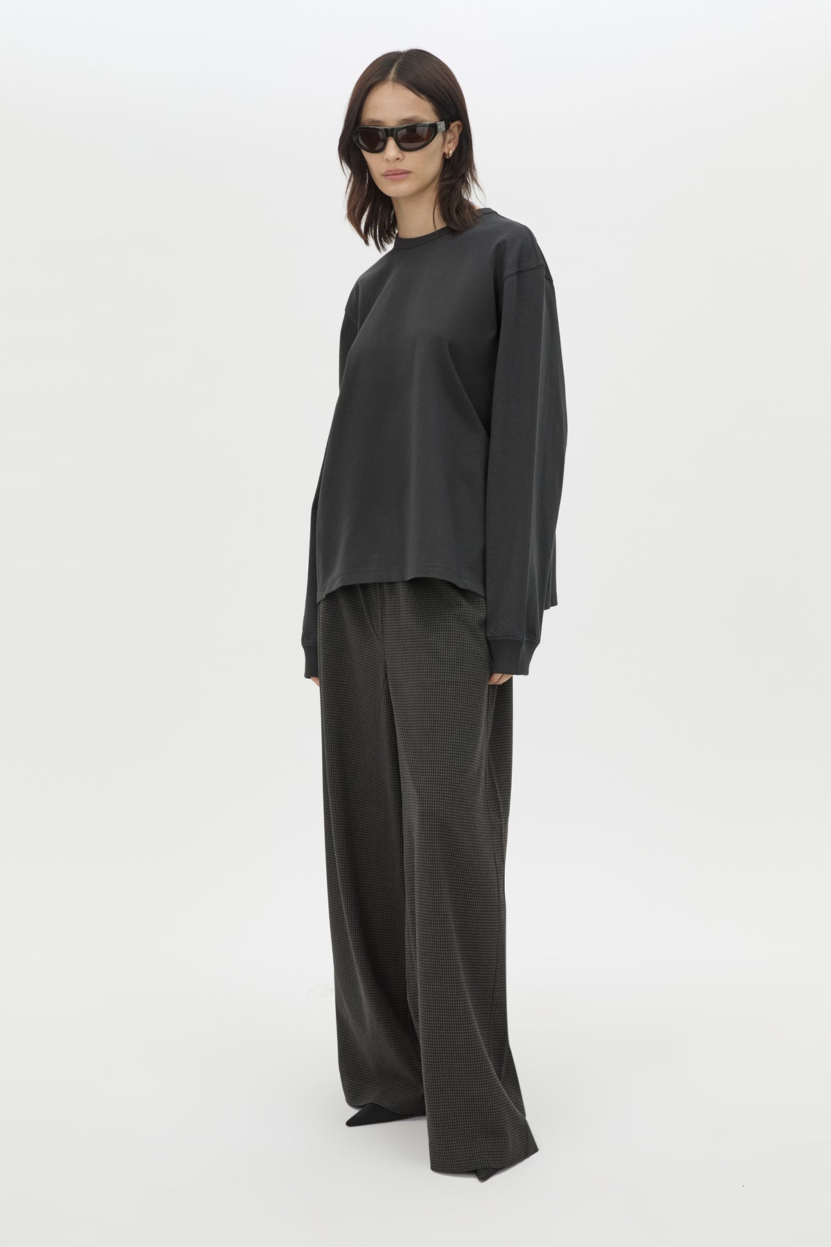Front styled view CAMILLA AND MARC Studio Graphic Long Sleeve Top in Grey with boucle embroidered monogram.  