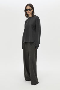 Front styled view CAMILLA AND MARC Studio Graphic Long Sleeve Top in Grey with boucle embroidered monogram.  