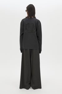 Back view CAMILLA AND MARC Studio Graphic Long Sleeve Top in Grey with boucle embroidered monogram.  