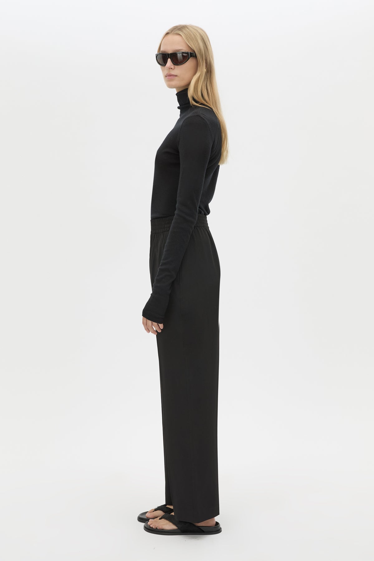 Side view CAMILLA AND MARC Sylvia soft suiting high-waisted pant in black with monogram patch at waistband.