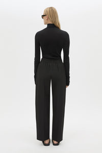 Back view CAMILLA AND MARC Sylvia soft suiting high-waisted pant in black with monogram patch at waistband.