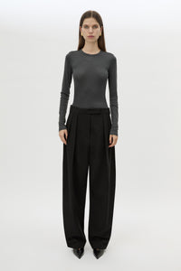 Front styled view CAMILLA AND MARC Tala Double Pleat Barrel Leg Pant in Black with pressed tapered legs.