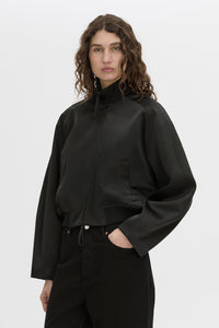 crop view CAMILLA AND MARC Tamar Satin Bomber Jacket in black with double‑ended zipper.