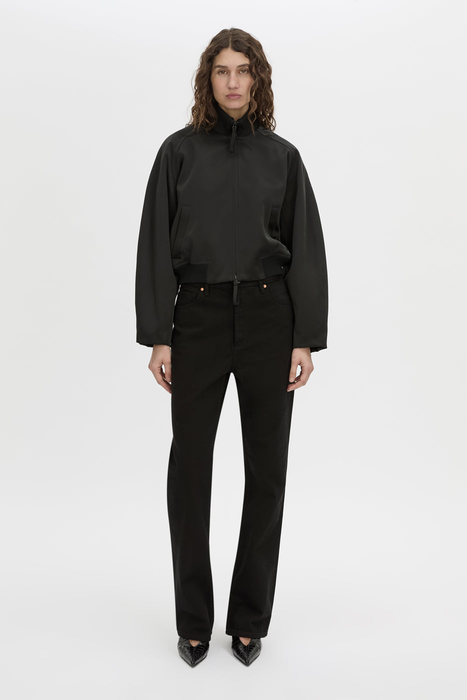 Front-styled view CAMILLA AND MARC Tamar Satin Bomber Jacket in black with double‑ended zipper.