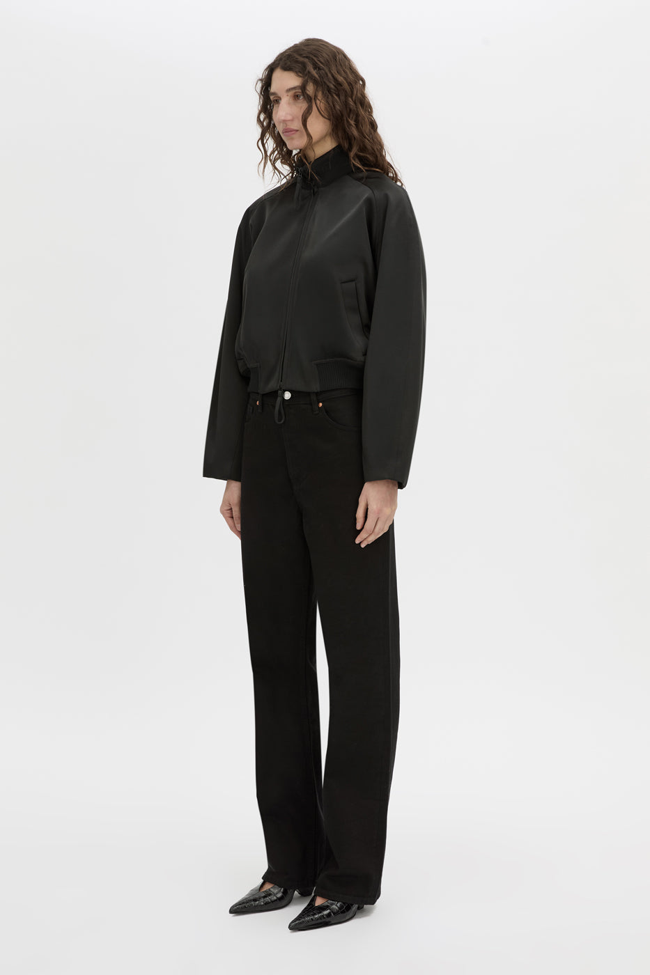 Side view CAMILLA AND MARC Tamar Satin Bomber Jacket in black with double‑ended zipper.