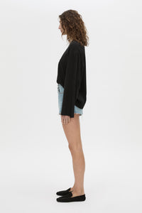 Side view CAMILLA AND MARC Tanner Denim Mini Short in light blue with raw‑hem.