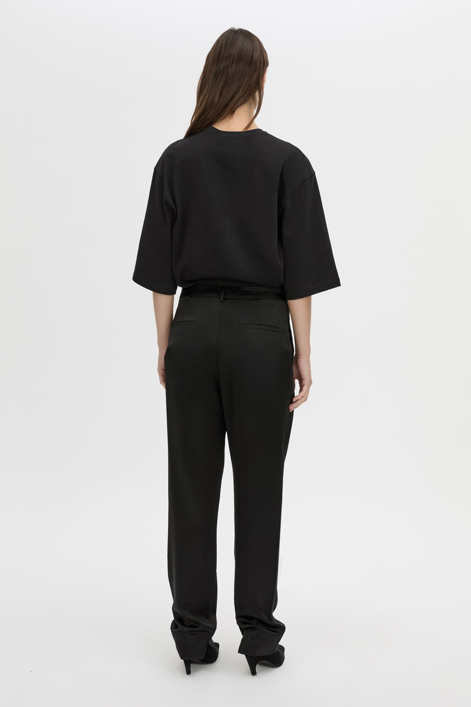Back view CAMILLA AND MARC Velin Pant in black with pleated bow‑leg design.