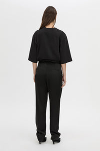 Back view CAMILLA AND MARC Velin Pant in black with pleated bow‑leg design.